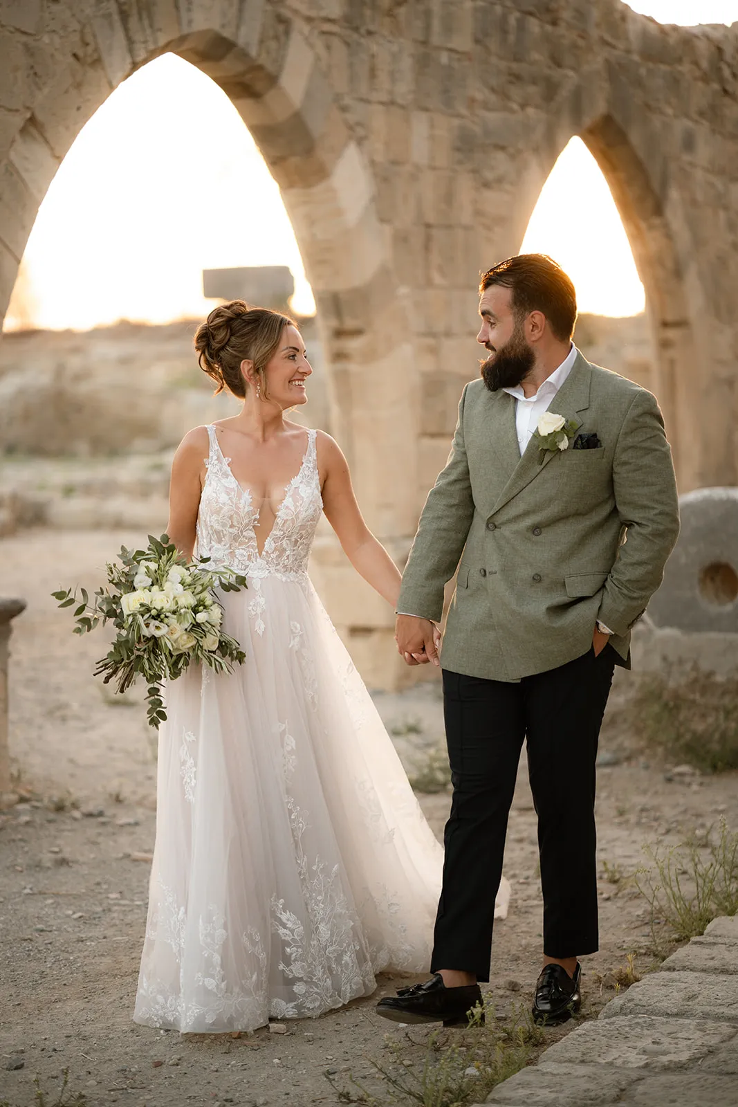 Couple under stone arches at golden hour — Cyprus wedding
