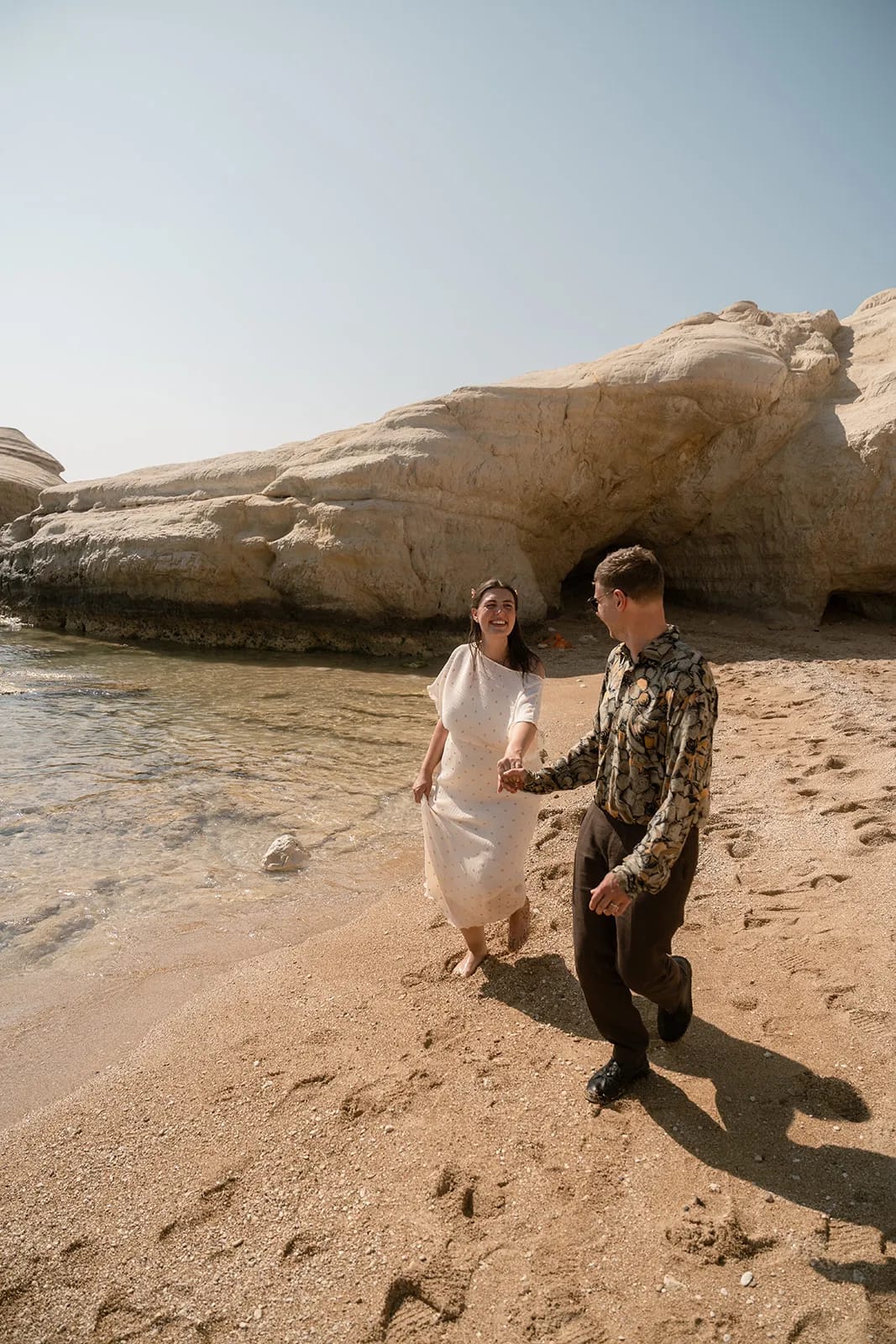 Couple on beach with rock formations — Cyprus wedding photography