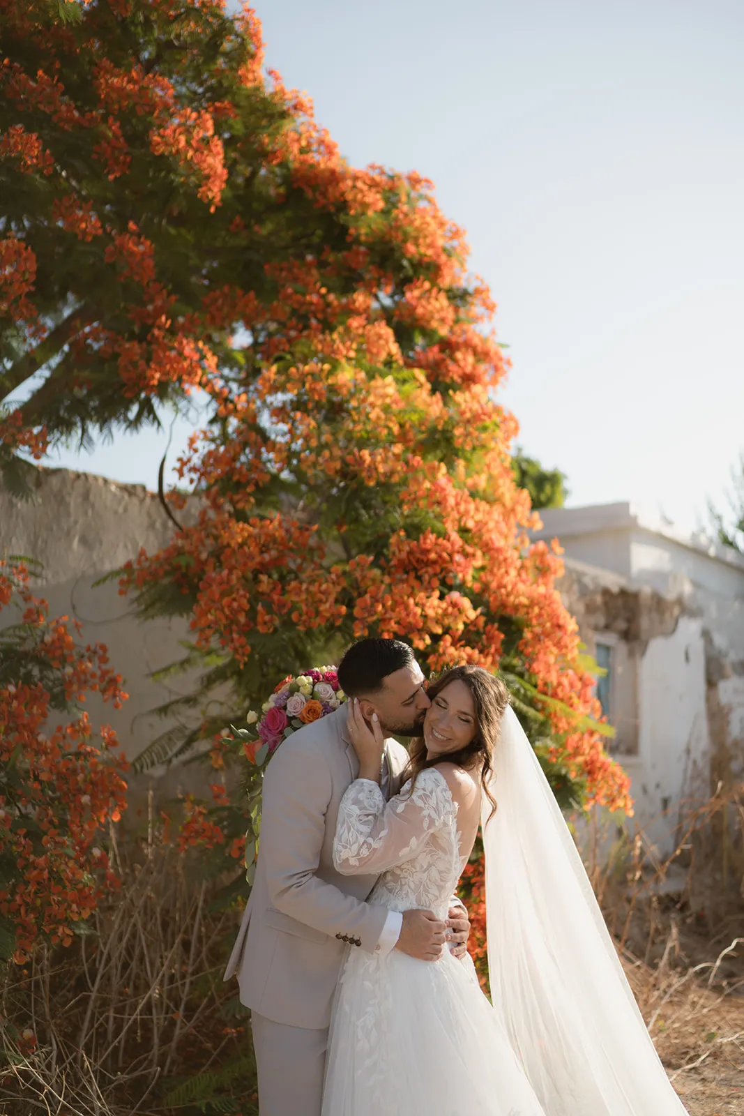 Kiss under flowering tree — romantic Cyprus wedding